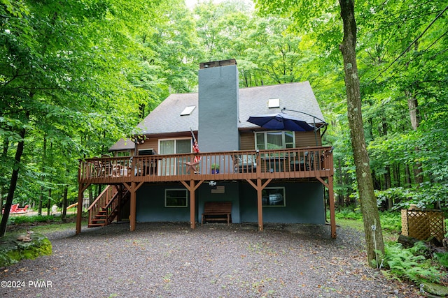 rear view of house with a wooden deck