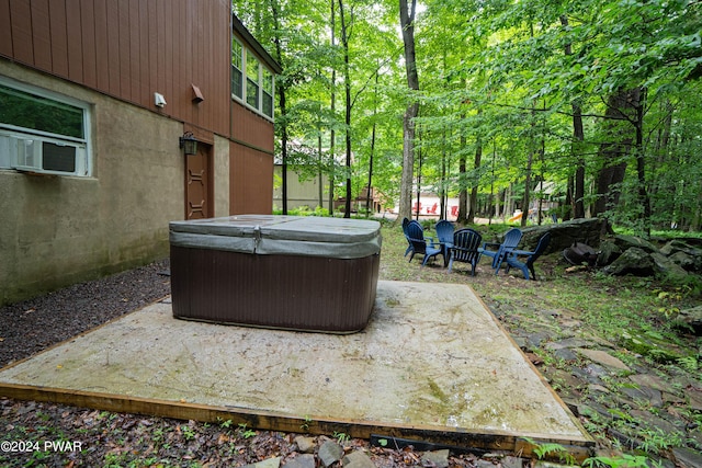 view of patio with cooling unit and a hot tub