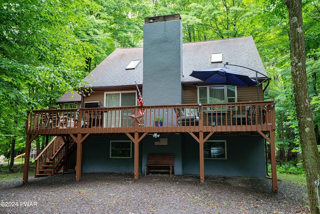 back of property featuring a deck