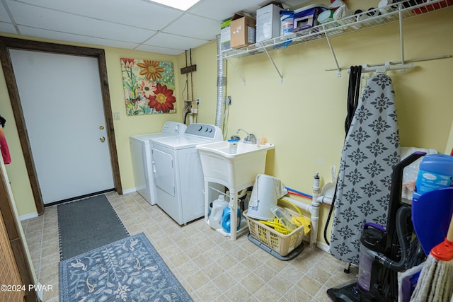 washroom featuring washing machine and clothes dryer and sink