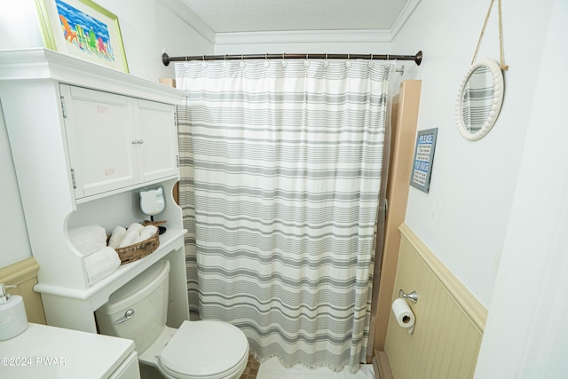 bathroom featuring walk in shower, crown molding, a textured ceiling, toilet, and vanity