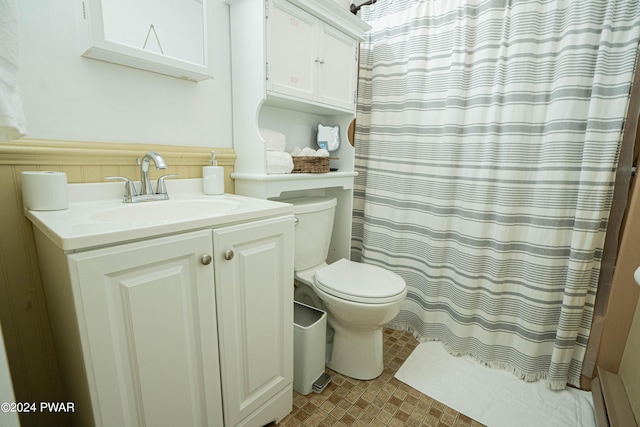 bathroom with walk in shower, vanity, and toilet