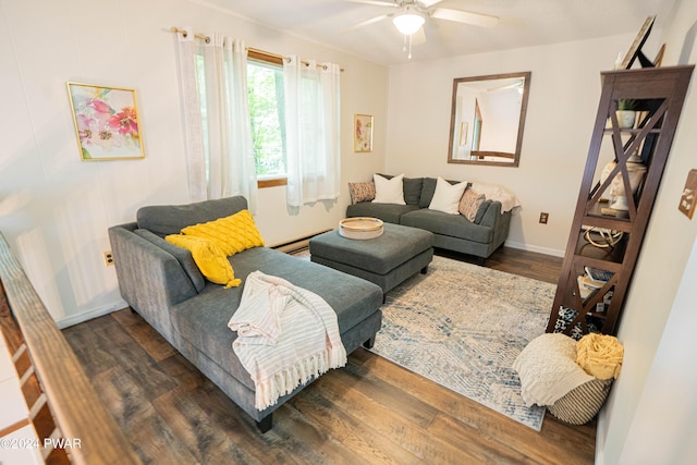 living room with dark hardwood / wood-style flooring, ceiling fan, and a baseboard heating unit