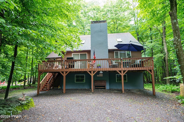 rear view of property with a wooden deck