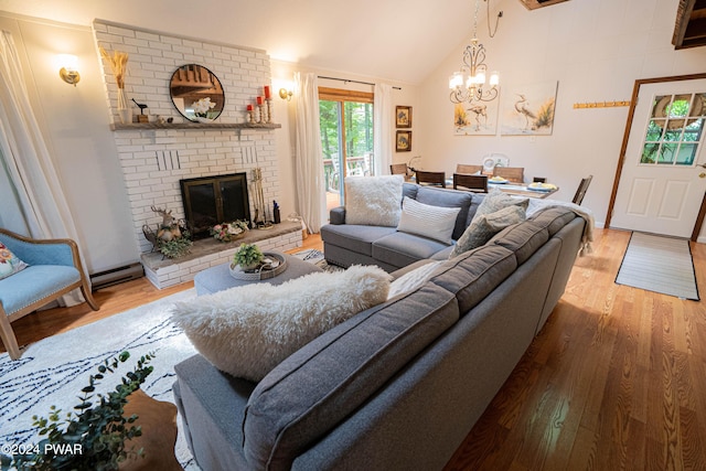 living room with wood-type flooring, a brick fireplace, lofted ceiling, and a notable chandelier