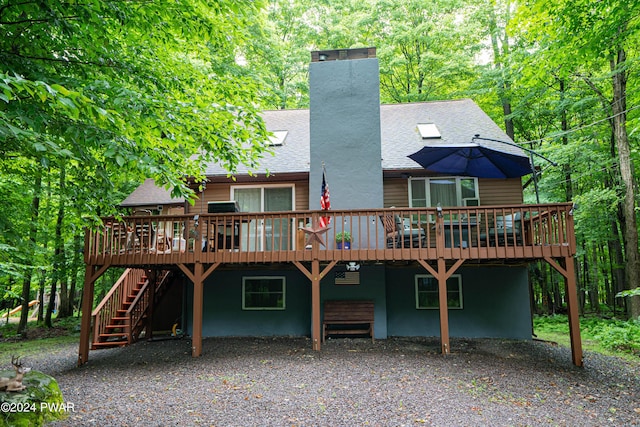 back of property featuring a wooden deck