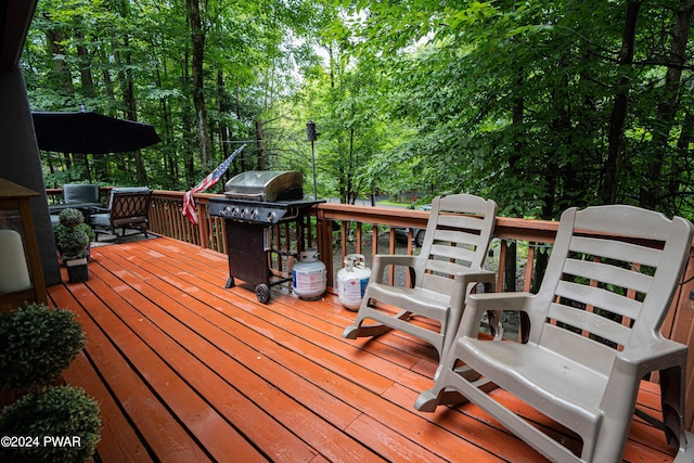 wooden terrace featuring a grill