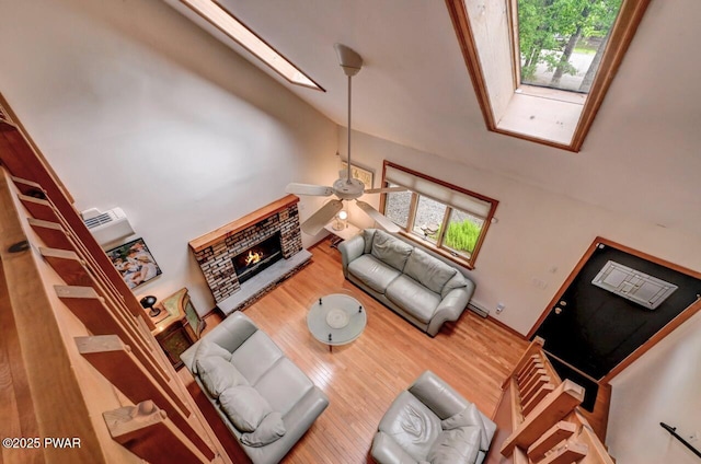 105 Chestnut Ct, Lackawaxen, PA 18435 - living area with high vaulted ceiling, wood finished floors, healthy amount of natural light, ceiling fan, and a fireplace