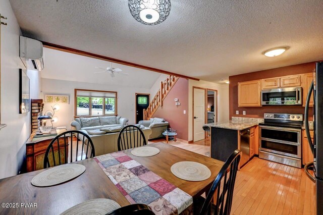 105 Chestnut Ct, Lackawaxen, PA 18435 - dining room with a wall mounted air conditioner, a textured ceiling, light wood finished floors, ceiling fan, and stairway