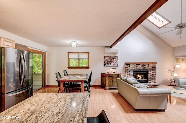 105 Chestnut Ct, Lackawaxen, PA 18435 - living area with an AC wall unit, light wood-style flooring, a skylight, and a ceiling fan