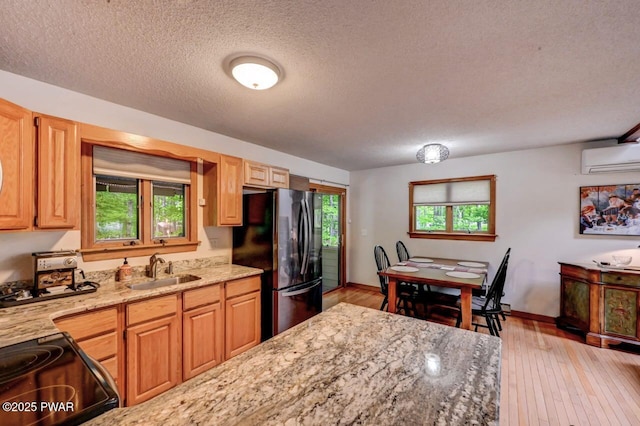 105 Chestnut Ct, Lackawaxen, PA 18435 - kitchen with freestanding refrigerator, a sink, electric range oven, a textured ceiling, and light stone countertops