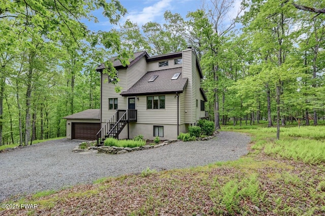 105 Chestnut Ct, Lackawaxen, PA 18435 - view of front of home featuring a chimney, a shingled roof, and a garage