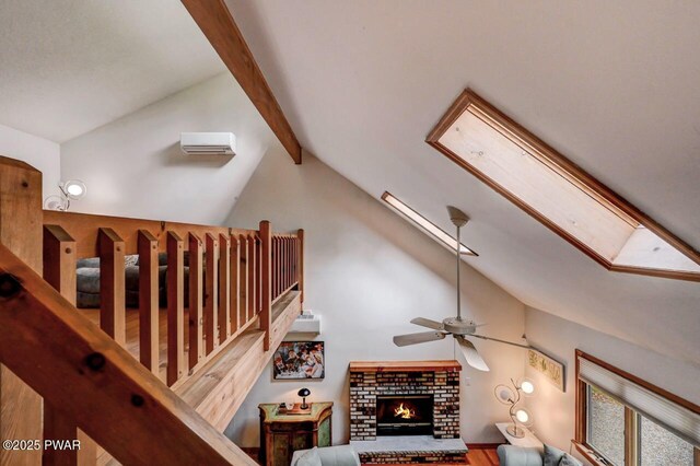 105 Chestnut Ct, Lackawaxen, PA 18435 - staircase featuring a ceiling fan, beamed ceiling, wood finished floors, a fireplace, and a skylight