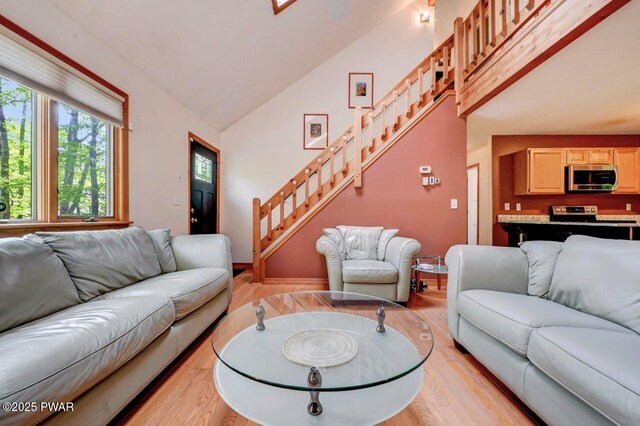 105 Chestnut Ct, Lackawaxen, PA 18435 - living room with light wood finished floors, stairs, and lofted ceiling