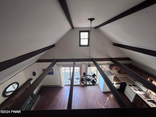 unfurnished living room with plenty of natural light, lofted ceiling with beams, and dark hardwood / wood-style flooring