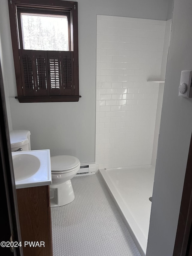 bathroom featuring tile patterned floors, walk in shower, vanity, a baseboard radiator, and toilet