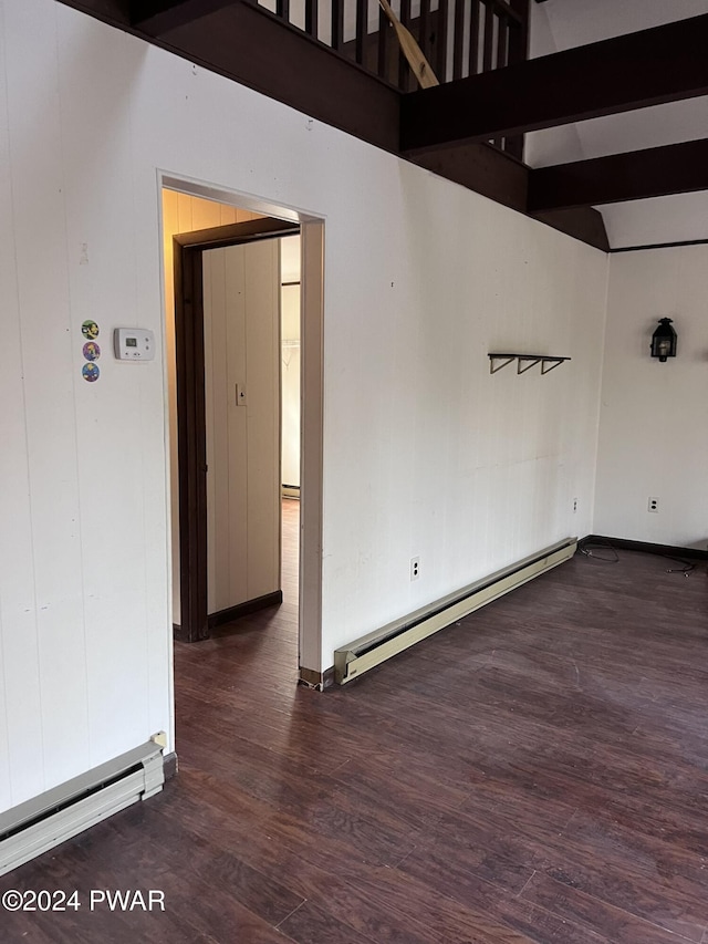 empty room featuring baseboard heating, dark hardwood / wood-style flooring, beamed ceiling, and high vaulted ceiling