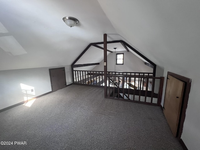 additional living space featuring carpet flooring and vaulted ceiling