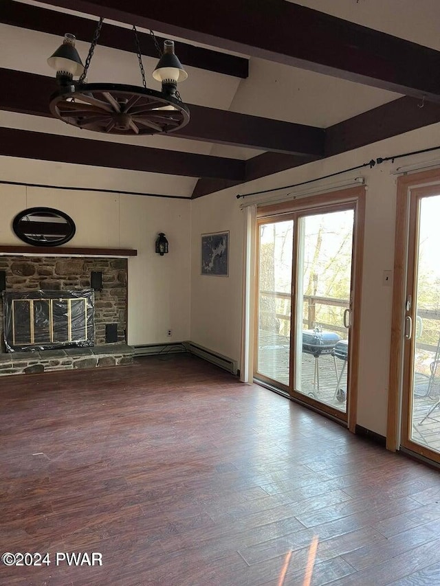 unfurnished living room featuring beam ceiling, a stone fireplace, a healthy amount of sunlight, and hardwood / wood-style flooring