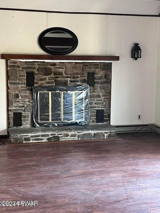 details with a stone fireplace and wood-type flooring