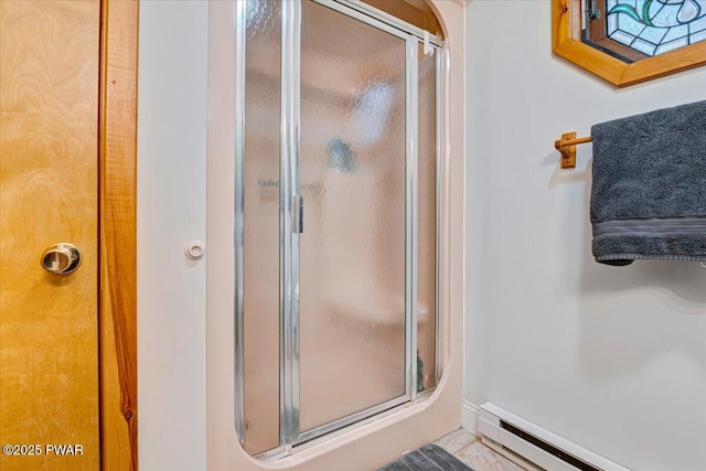 bathroom with baseboard heating and a shower with door