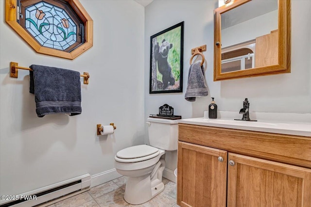 bathroom featuring toilet, vanity, tile patterned flooring, a shower with shower door, and baseboard heating