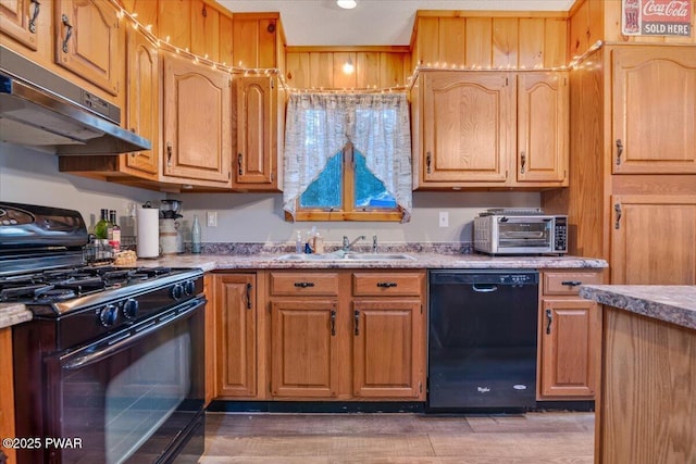 kitchen featuring light stone countertops, sink, dark hardwood / wood-style floors, and black appliances