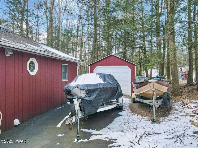 exterior space featuring a garage and an outbuilding