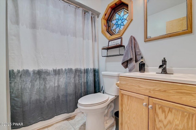 bathroom featuring toilet and vanity