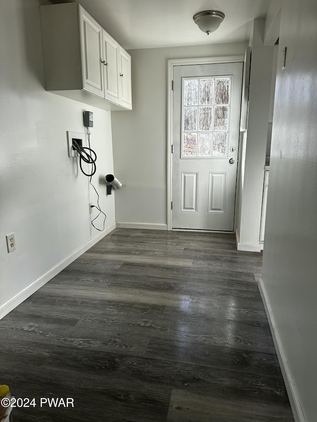 clothes washing area featuring cabinets, washer hookup, and dark hardwood / wood-style floors