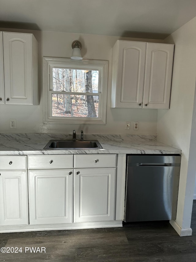 kitchen with dishwasher, light stone countertops, white cabinetry, and sink