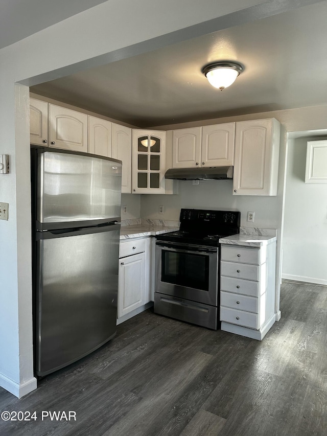 kitchen with light stone counters, white cabinetry, stainless steel appliances, and dark hardwood / wood-style floors