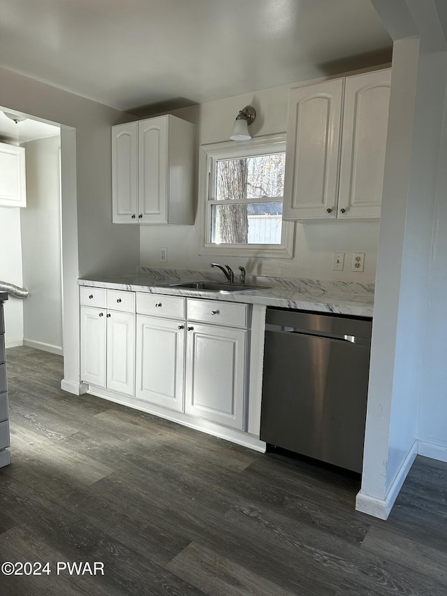 kitchen with light stone countertops, sink, dark hardwood / wood-style flooring, stainless steel dishwasher, and white cabinets