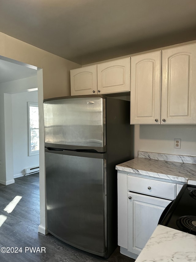 kitchen featuring baseboard heating, dark hardwood / wood-style flooring, stainless steel fridge, white cabinets, and range