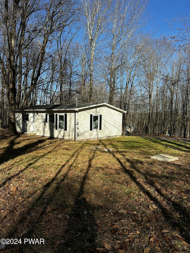 view of outbuilding featuring a yard