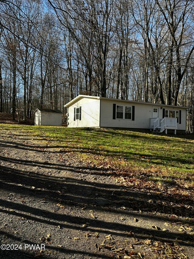 exterior space with a yard and a storage shed