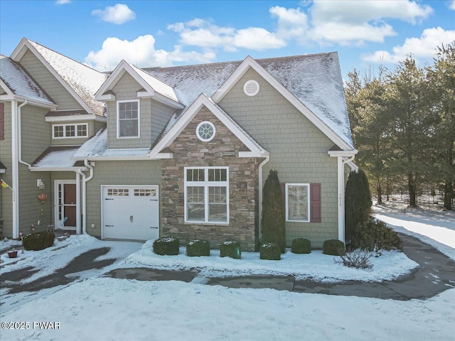 view of front of property featuring a garage and stone siding