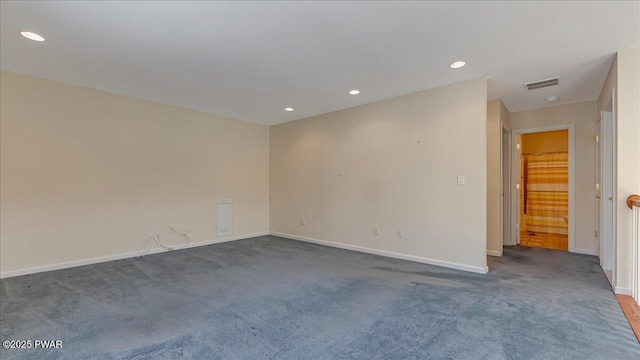 empty room with baseboards, visible vents, dark carpet, and recessed lighting