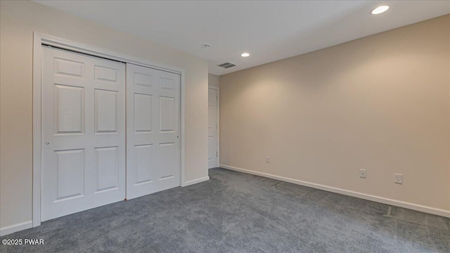 unfurnished bedroom featuring baseboards, visible vents, dark colored carpet, and recessed lighting