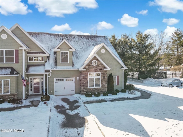 craftsman house with stone siding and an attached garage