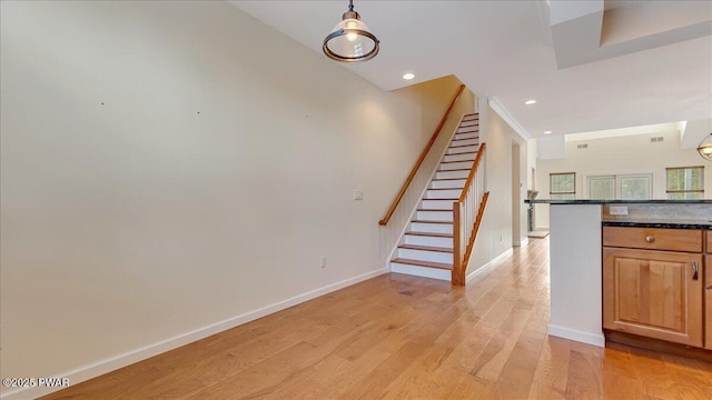 stairs featuring recessed lighting, baseboards, and wood finished floors