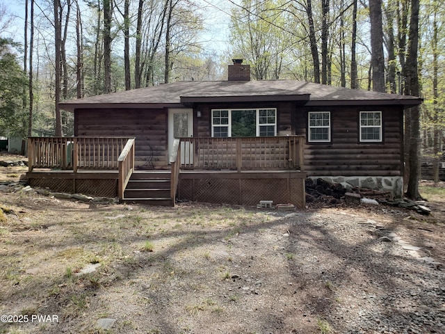 103 Hickory Dr, Greentown, PA 18426 - view of front of house with log veneer siding, a chimney, a shingled roof, and a wooden deck