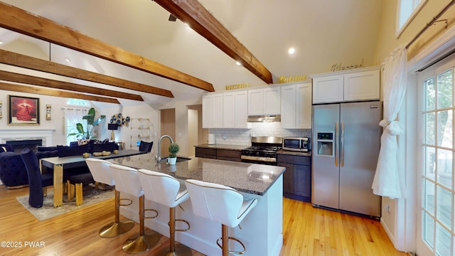 785 Milford Rd, Dingmans Ferry, PA 18328 - kitchen featuring appliances with stainless steel finishes, white cabinetry, decorative backsplash, dark stone countertops, and light wood-type flooring