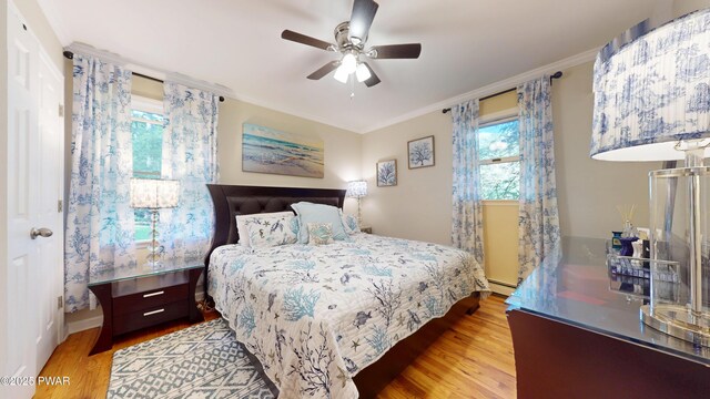 785 Milford Rd, Dingmans Ferry, PA 18328 - bedroom featuring wood finished floors, ornamental molding, a baseboard heating unit, and a ceiling fan