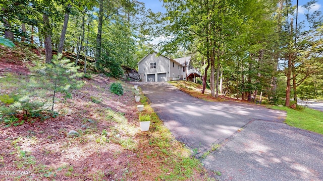 785 Milford Rd, Dingmans Ferry, PA 18328 - view of front of house featuring an attached garage and asphalt driveway