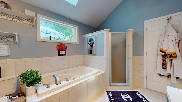 785 Milford Rd, Dingmans Ferry, PA 18328 - full bath featuring a garden tub, a skylight, a shower stall, lofted ceiling, and tile patterned floors