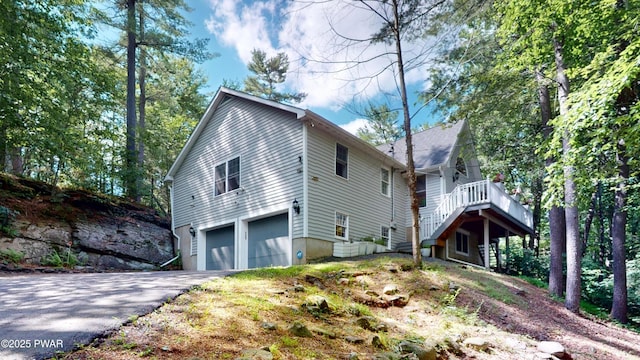 785 Milford Rd, Dingmans Ferry, PA 18328 - view of front facade with driveway, an attached garage, and stairway