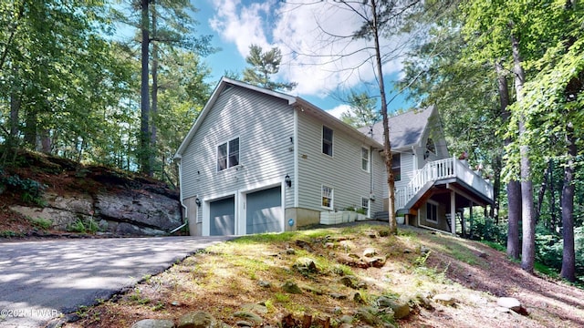 785 Milford Rd, Dingmans Ferry, PA 18328 - view of home's exterior with driveway, an attached garage, and stairway
