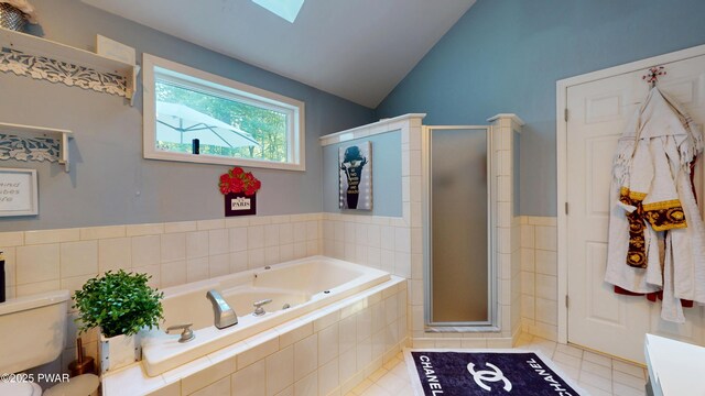 785 Milford Rd, Dingmans Ferry, PA 18328 - full bath featuring a garden tub, a skylight, a shower stall, lofted ceiling, and tile patterned floors