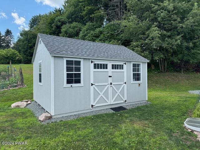 view of outbuilding featuring a yard